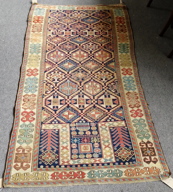 A Caucasian prayer rug, the dark indigo mehrab with a bold interconnecting trellis of serrated leaves and lower medallions, plant spandrels, an ivory