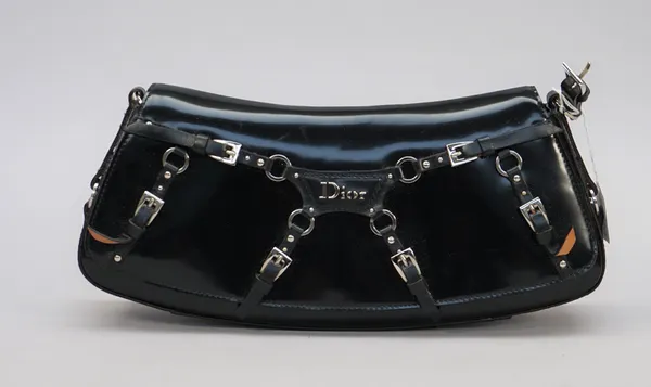 A Dior buckle embellished black patent leather clutch bag of curved rectangular shape and silver tone hardware, missing strap, and a Christian Dior na