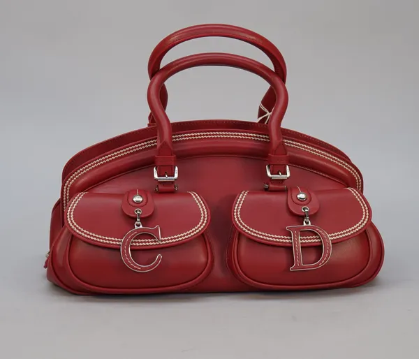 A Christian Dior red calf leather detective bag with two top handles and two exterior buckle front pockets with double white stitched detailing and su