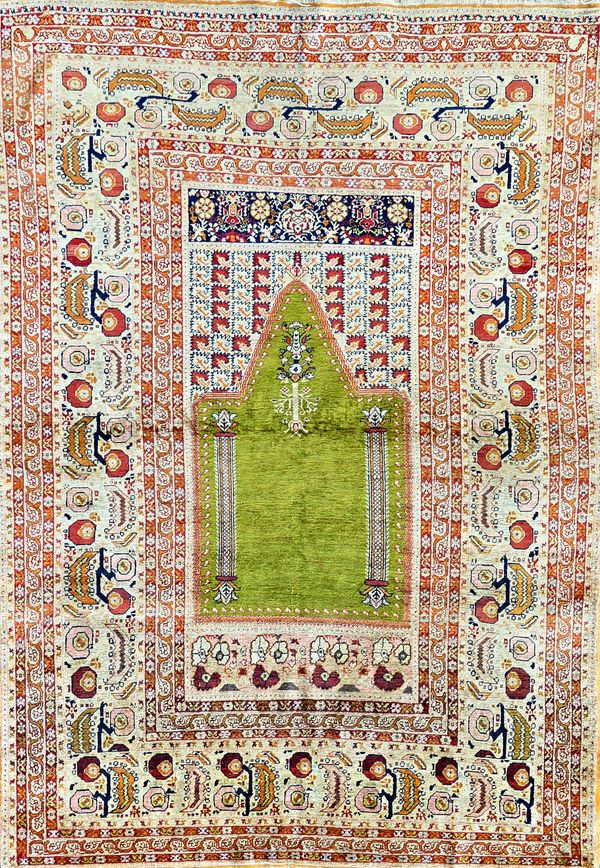 A part silk prayer rug, possibly Ghiordes or Sivas, central mihrab design with stylised hanging lantern on a olive green ground, pale fawn and iron re