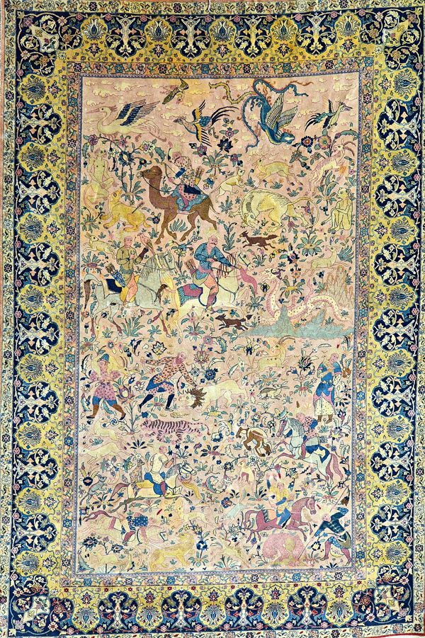 A fine Tabriz hunting carpet, Persian, the pale dull pink field with a landscape filled with horseman hunting a variety of wild animals; an interconne