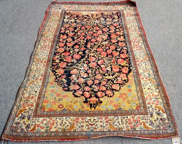 A Kashan tree of life prayer rug, Persian, the dark indigo mehrab with an abundantly floral tree of life, with birds and animals beneath a golden arch