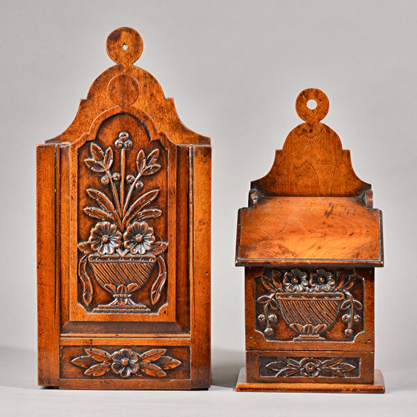 A 19th century French carved walnut wall mounted salt/spice box with slope front, 23cm wide x 49cm high, together with another smaller, 20cm wide x 40