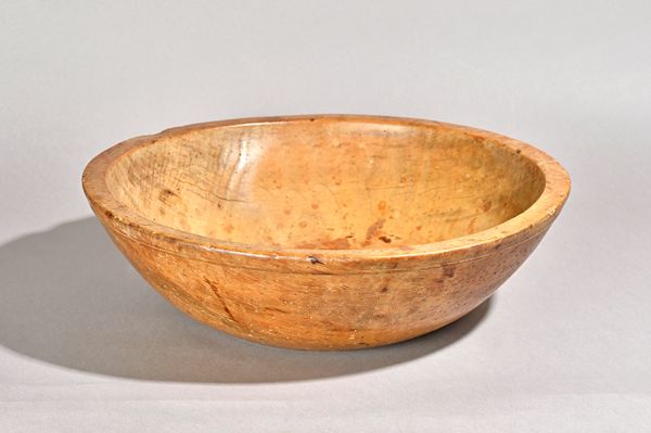 A large 19th century sycamore turned bowl, 45cm diamater x 14cm high. Illustrated.