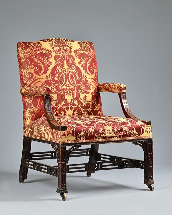 A George III mahogany Gainsborough chair, with blind fret decoration on square supports, 71cm wide x 104cm high. Illustrated.