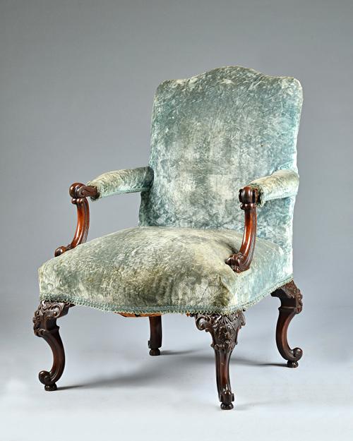 A 19th century Irish mahogany open armchair, on four carved scroll supports, 70cm wide x 100cm high. Illustrated.