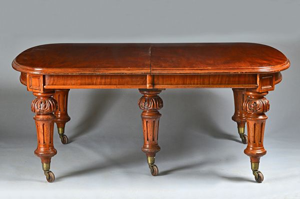 A large Victorian mahogany extending dining table, on acanthus capped fluted supports, five extra leaves, 146cm wide x 186cm long x 438cm long extende