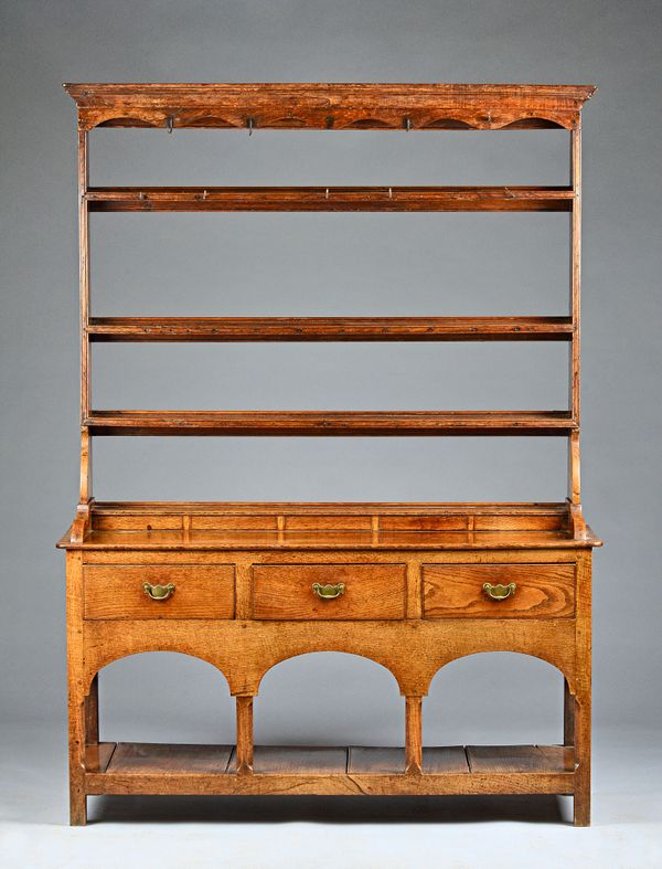 A mid-18th century oak dresser, the open three tier plate rack over three frieze drawers united by pot bound undertier, 139cm wide x 190cm high. Illus