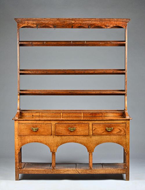 A mid-18th century oak dresser, the open three tier plate rack over three frieze drawers united by pot bound undertier, 139cm wide x 190cm high. Illus
