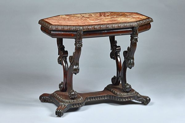 After a design by Thomas King; a cylonese solid rosewood centre table, the compressed octagonal top on four scroll supports 92cm wide x 74cm high. Ill