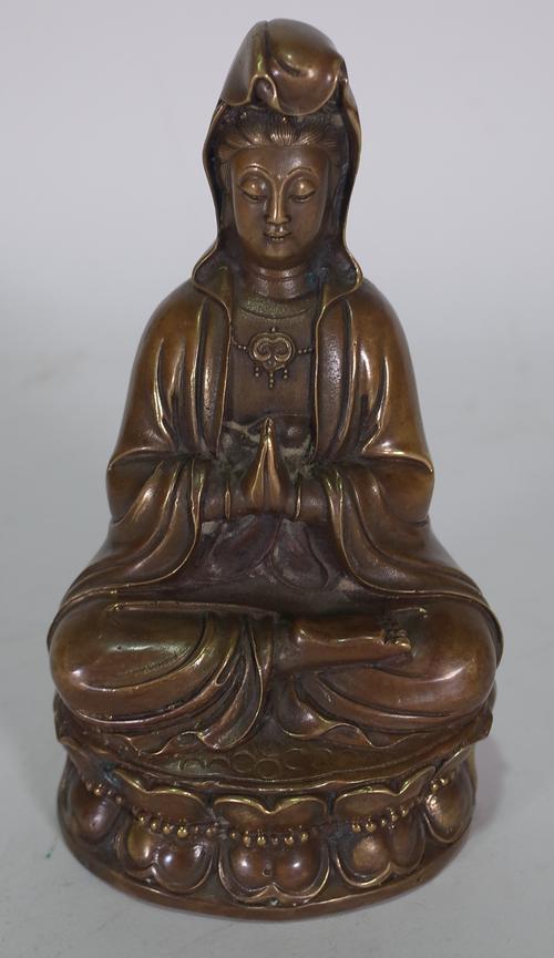 A Chinese bronze figure of Guanyin, 19th century, seated in dhyanasana on a double lotus base, 19.5cm.high.