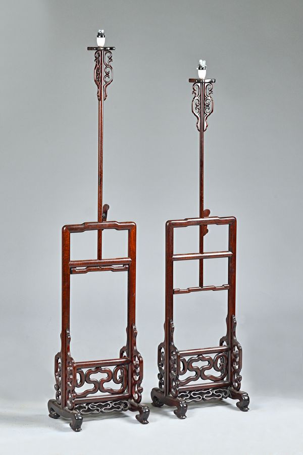 A pair of Chinese hardwood height adjustable standard lamps with open frames, 32cm wide x 156cm high max, (2).Illustrated.