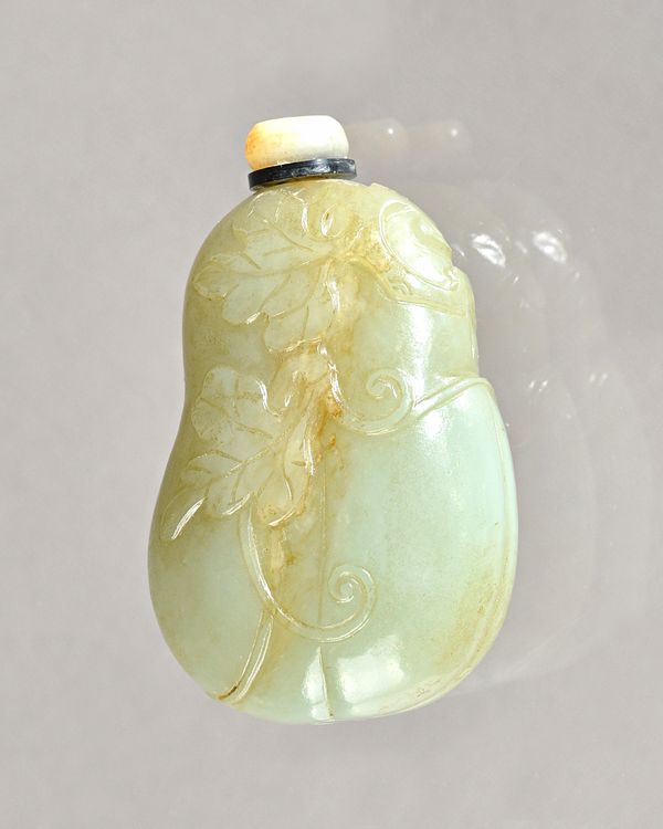 A Chinese celadon jade snuff bottle, 19th century, carved as a gourd with trailling vine leaves to each side, 5.7cm. high, (2). Provenance: Christie's