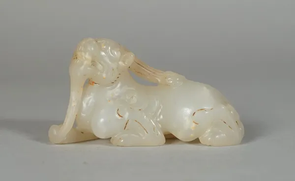 A Chinese small white jade mythical creature, carved in a recumbent pose, 5.5cm. length.