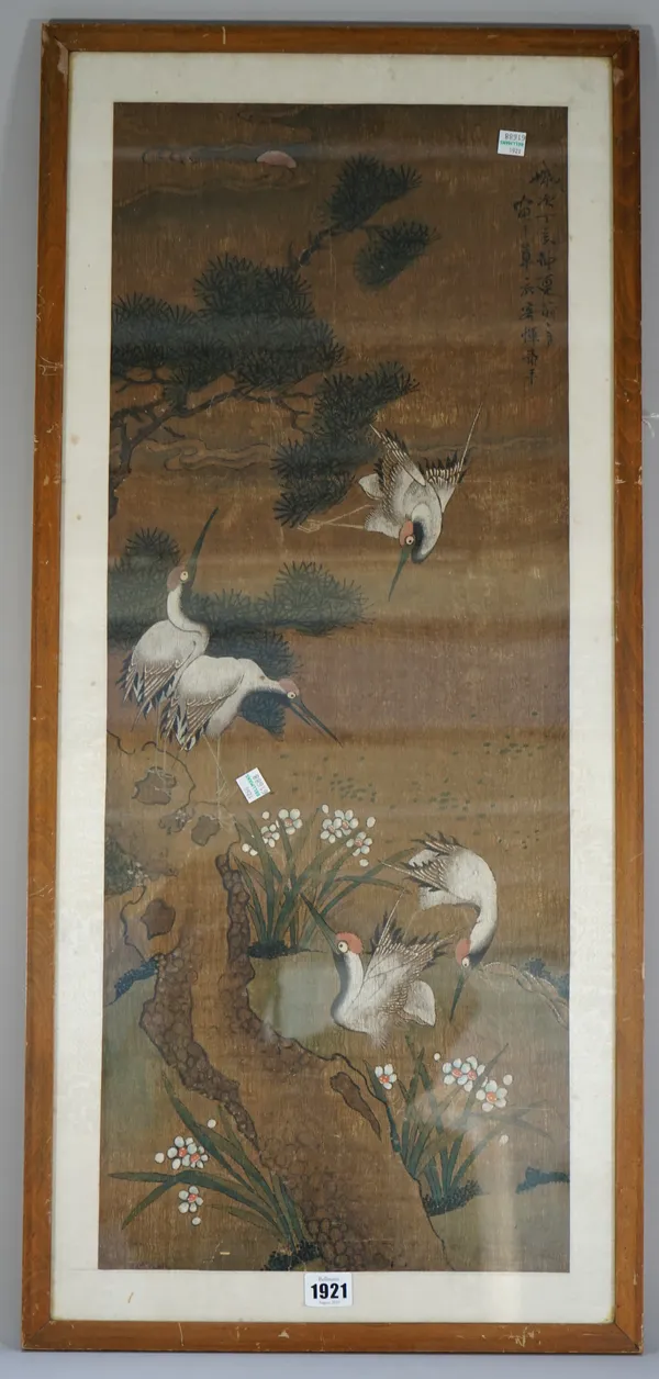 A Chinese painting on silk. 19th/early 20th century, painted with storks, a pine tree and flowers, bears signature, 80cm. by 31cm., framed and glazed.