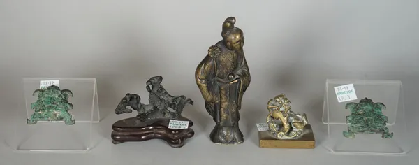 A group of Chinese bronzes, various dates, comprising; a figure of a woman standing with a flower, 13cm. high; a small figure of a buddhist lion on re