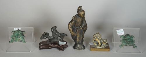 A group of Chinese bronzes, various dates, comprising; a figure of a woman standing with a flower, 13cm. high; a small figure of a buddhist lion on re