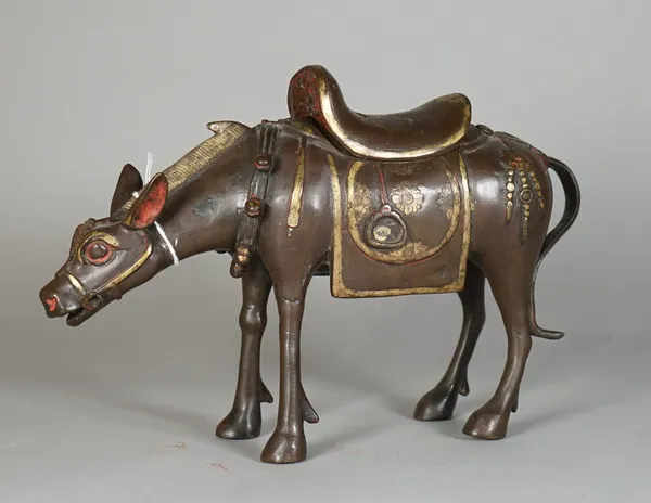 A Chinese bronze censer and cover, modelled as a mule standing four-square, the saddle forming the cover, picked out in gilding with red painted detai