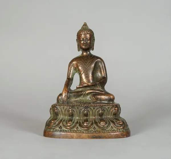 A small copper alloy figure of Buddha, probably 19th century, seated in vajrasana on a double lotus base, 9cm. high