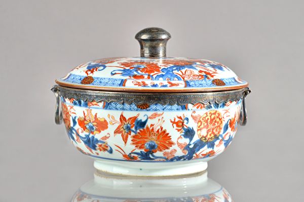 A Chinese Imari silver-mounted circular bowl and cover, the porcelain circa 1720-50, painted to the interior with a panel of flowers beneath a diaper