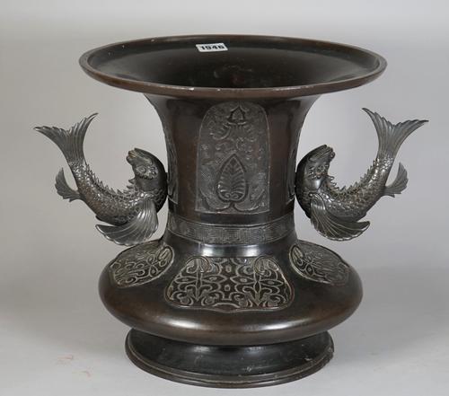 A Chinese bronze two-handled vase, 19th century, the squat body decorated with foliate panels beneath a waisted neck decorated with lappets, the separ