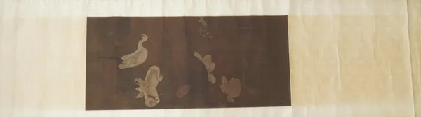 A scroll painting on silk, Chinese or Japanese, probably 19th century, painted with three storks in a landscape with a smaller bird and lotus, signed,