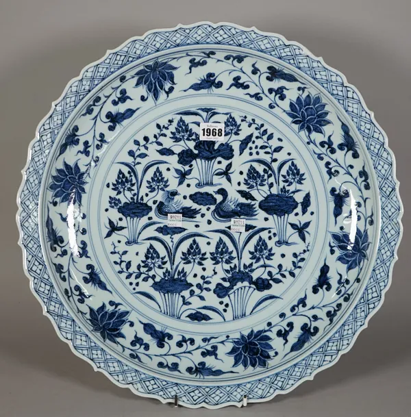 A large Chinese Yuan- style blue and white dish, modern, painted with ducks on a lotus pond, 46.5cm. diameter; and another blue and white dish painted