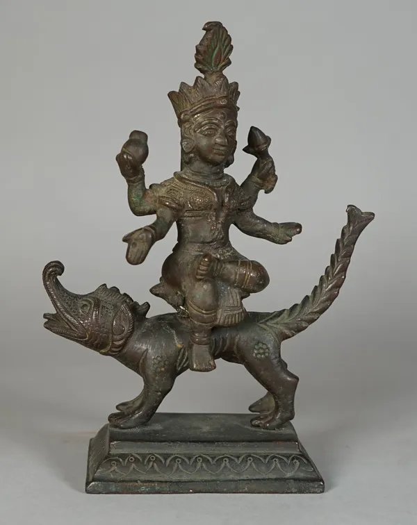 An Indian bronze figure of the goddess Ganga, probably 18th/19th century, seated on the back of her makara, her upper arms holding kalasa and padma, r