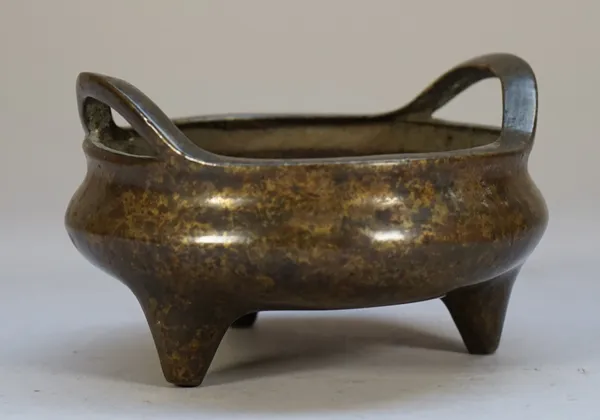 A small Chinese bronze two-handled censer, six character Xuande mark but later, of compressed circular form raised on three peg supports, 12cm. wide.