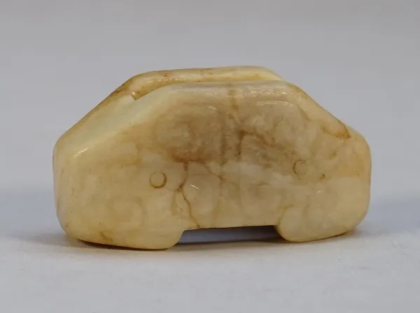 A Chinese jade sword slide, probably Han dynasty, one side carved with a chilong, the reverse with scrolls, the stone of cream tone with brown inclusi