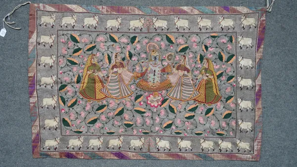 An Indian embroidered pichvai, late 19th/20th century, depicting Srinathji and four gopis on a silver ground filled with lotus, inside a border spaced