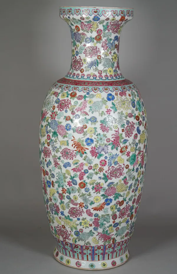 A Chinese famille-rose baluster vase, 20th century, printed and coloured with flowers beneath ruyi-head borders, 63cm. high, adapted as a lamp.