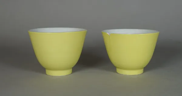 A pair of Chinese lemon yellow- ground teabowls, 20th century, indistinct blue four character mark, possibly `Hall for the cultivation of virtue', (a.