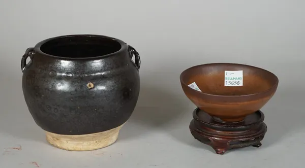 A Chinese brown glazed pottery jar, probably Song dynasty, set with two small loop handles, the interior and exterior covered in a deep brown glaze fa