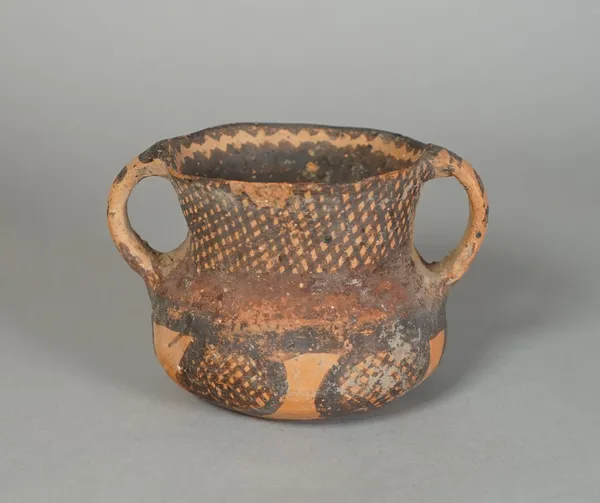 A small Chinese red earthenware two-handled vase, Neolithic period, circa 3rd century BC, painted with a stylised design, 7cm. high.