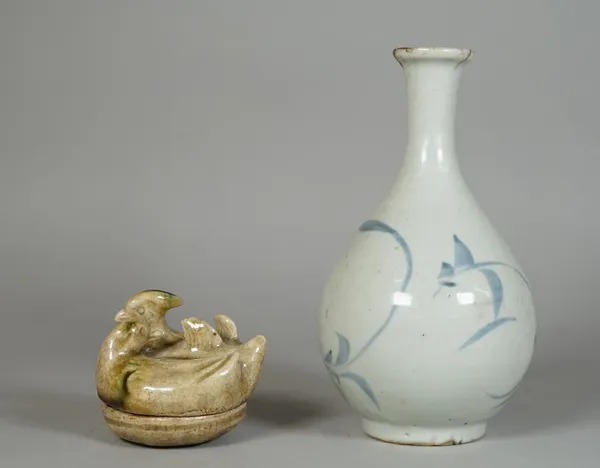 A Korean blue and white pear shaped vase, probably 19th century, painted with stylised branches, (a.f), 17cm, high; also a green glazed pottery small