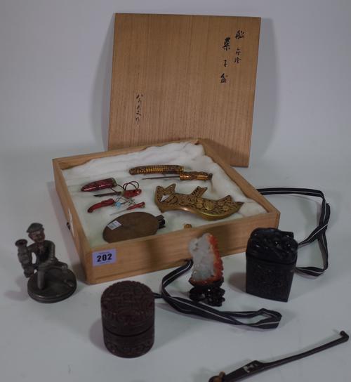 Asian interest, including: a red carved wooden box, a jade carving, a Chinese metal figural candlestick and sundry, (qty).