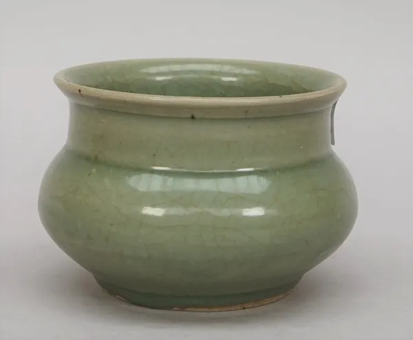 A Chinese longquan celadon jar, probably Song dynasty, the squat body covered in an olive green glaze, 9cm. high.