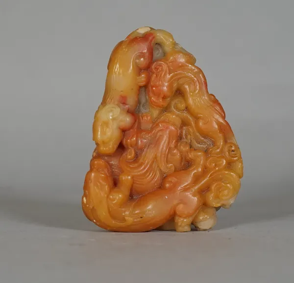 A Chinese soapstone carving, late 19th/20th century, carved with four chilong amongst scrolls, 8cm. high.