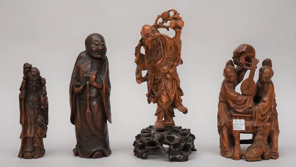 A Chinese boxwood figure of Shoulao, carved standing carrying a branch of fruiting peaches across his shoulders, 19cm. high, wood stand; also a wood g