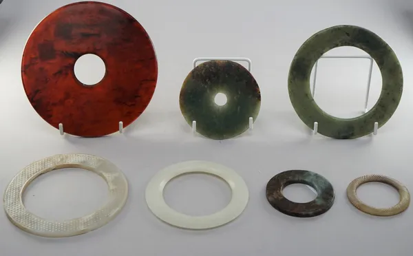 A group of seven Chinese jade bi discs and bangles, of various size and colour, 5.5cm. to 13.5cm. diameter, (7).