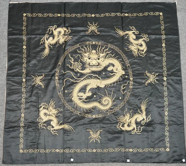 A Chinese black-ground embroidered tableloth, 20th century, worked in high relief in gilt wire with a central dragon roundel, framed by insects and fu