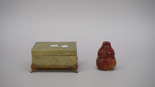 A Chinese soapstone gourd shaped water dropper or snuff bottle, 20th century, carved with gourds and leafy branches, the reverse with rows of calligra