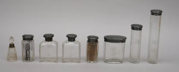 Four Victorian silver topped faceted glass toilet jars, with engraved decoration to the tops, Sheffield 1879, three further faceted glass toilet bottl