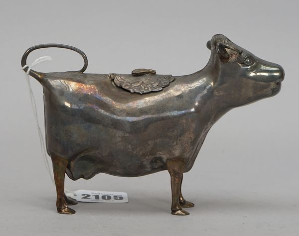 A silver cow creamer, modelled as a standing cow, the hinged cover with a fly motif within a floral wreath surround, the tail formed as the handle, Lo