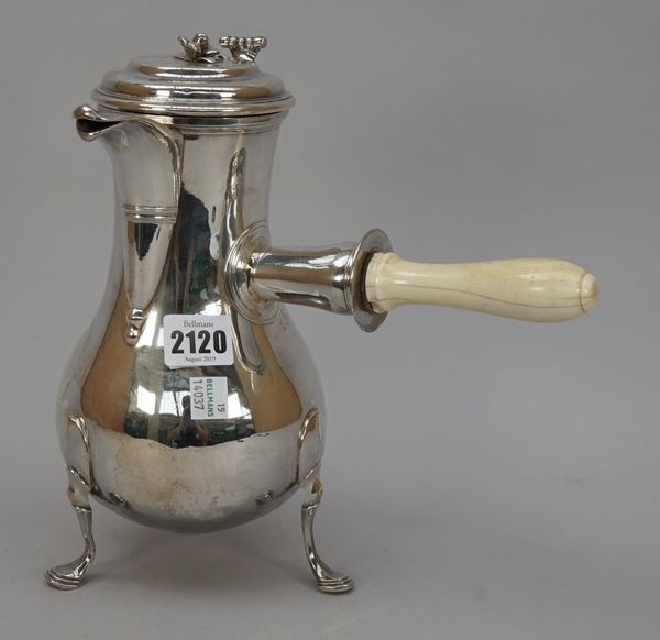 A French provincial coffee pot, of baluster form, the hinged lid with a scroll thumbpiece and with a bud finial, the body with a detachable ivory hand