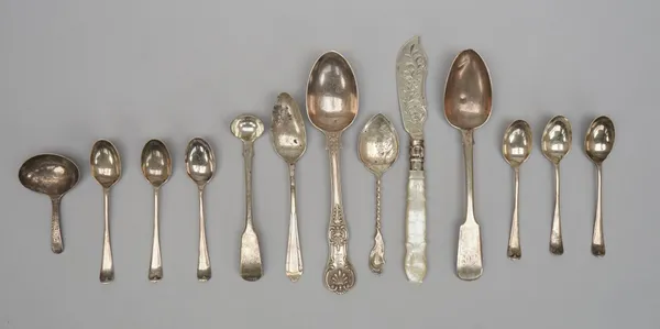 A George III silver caddy spoon, the bowl of oval form with engraved decoration, probably London 1800, a Victorian silver butter knife with engraved d