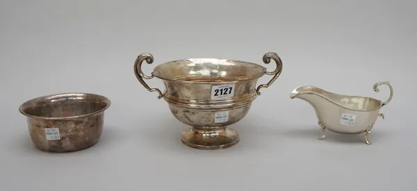 Silver, comprising; a twin handled trophy bowl, presentation inscribed, Birmingham 1912, a circular bowl, inscribed,  Birmingham 1919 and a sauceboat,