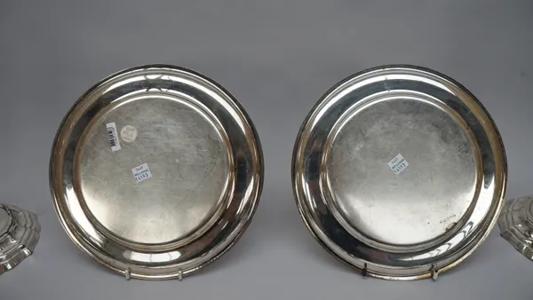 Plated wares, comprising; six circular plates, decorated with gadrooned rims, diameter 24.5cm and a pair of table candlesticks, each raised on a shape