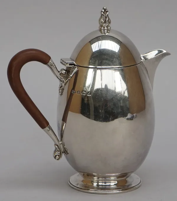 A silver three piece part tea set, comprising; a hot water jug, a twin handled sugar bowl and a milk jug, each piece of curved form, the hot water jug